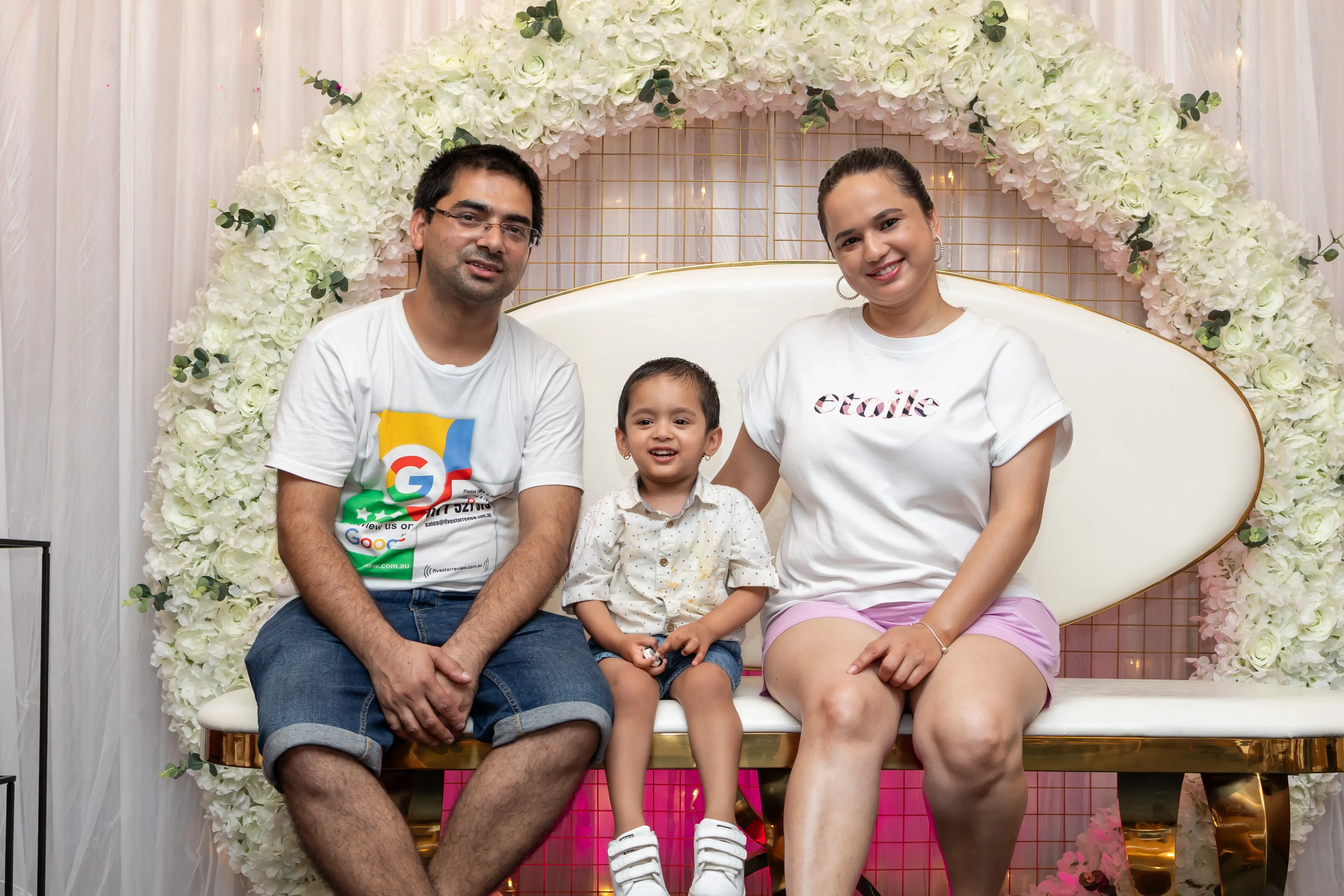 A family photo of a couple and their baby at a function, dressed in semi-formal attire and posing for the camera. All are smiling and enjoying the event at Third Eye Windsor, 515 George St, South Windsor NSW 2756.